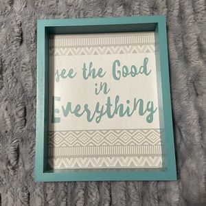 Blue, gray, and white decorative plaque.